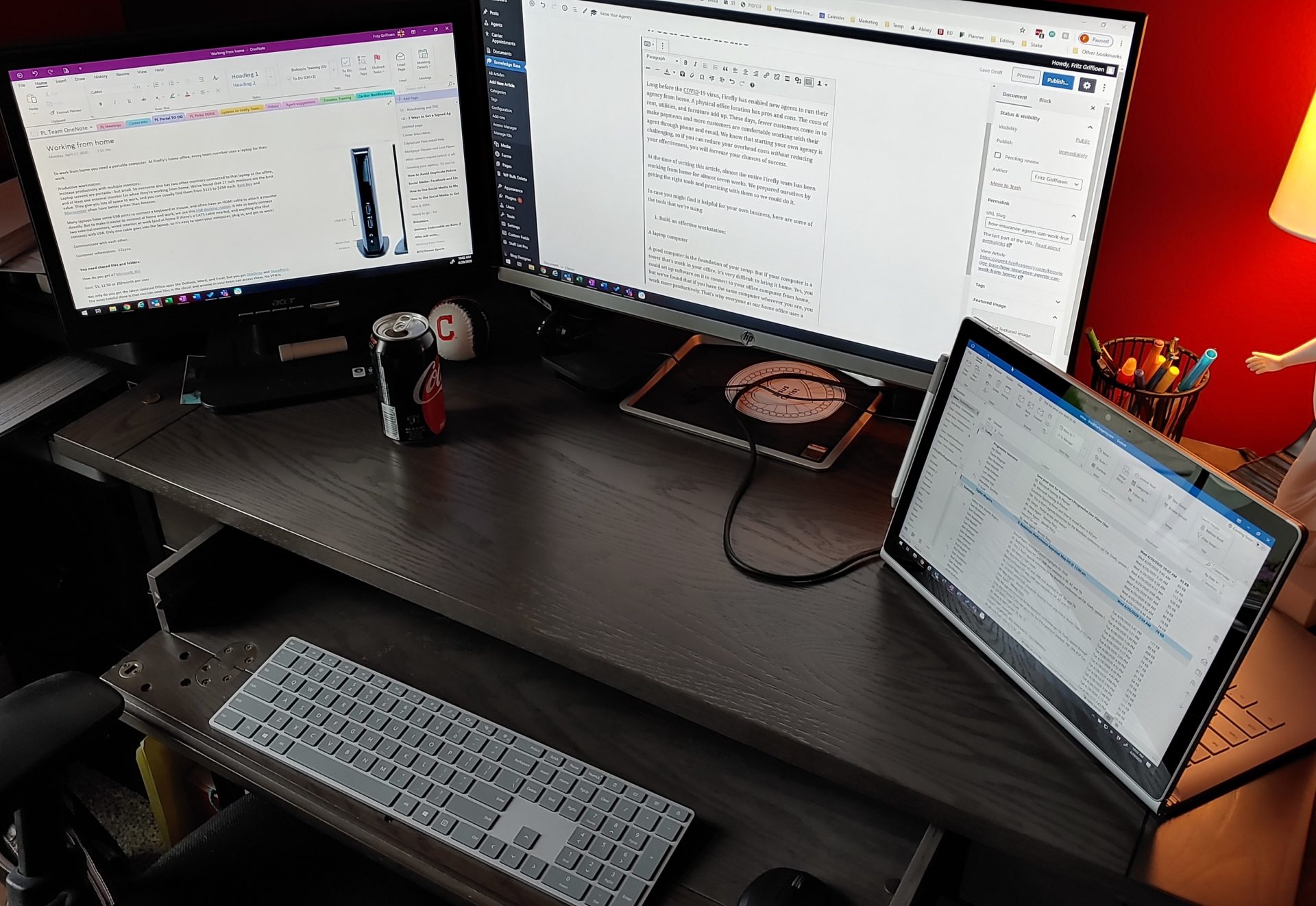 Two monitors and a laptop on a desk.