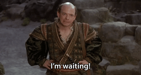 Gif of a man shrugging and saying "I'm waiting".