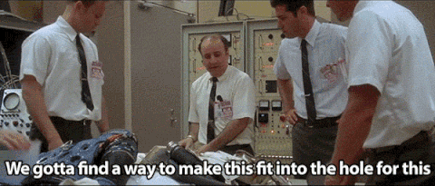 3 men discussing a shuttle fix option in an Apollo 13 movie scene.