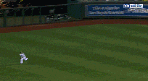 Video of a a professional baseball player missing a ball in the outfield during the World Series.